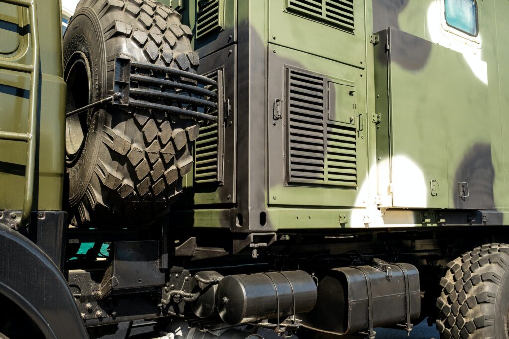 A close-up of the body of a military car on the side is green. Military concept