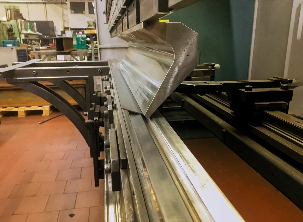 Sheet metal bending in factory machine in metal fabrication
